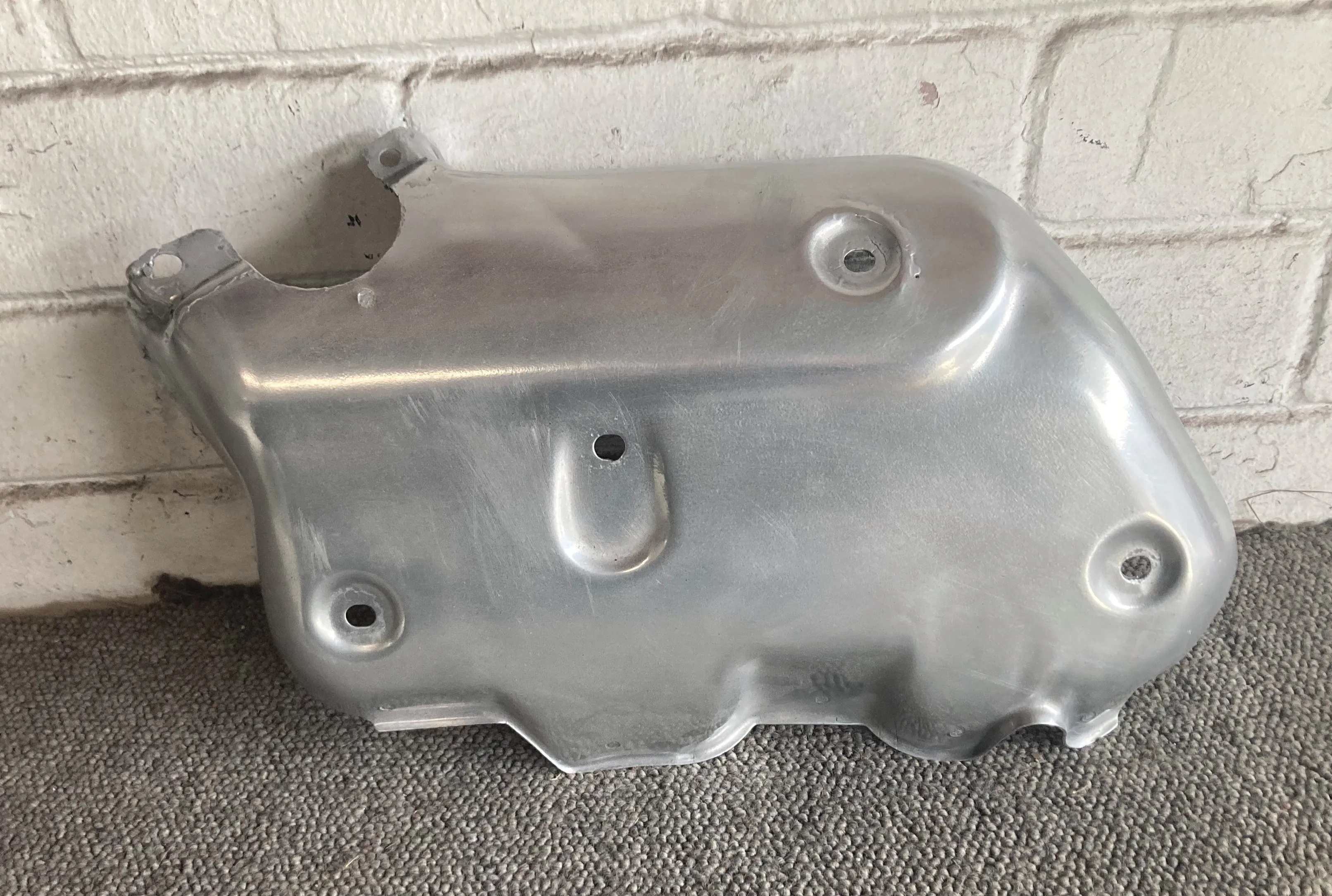 A bare-metal motorcycle heat shield