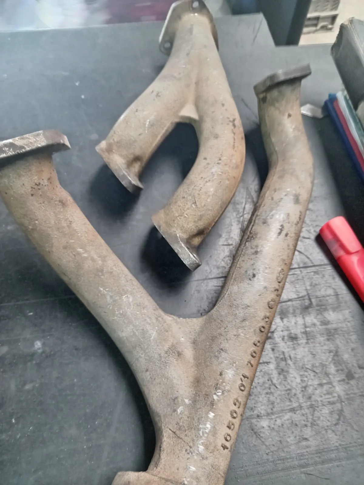 A heat-discoloured exhaust manifold before coating
