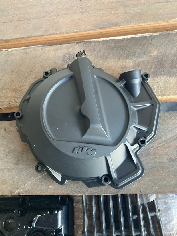 A coated dirt-bike engine cover