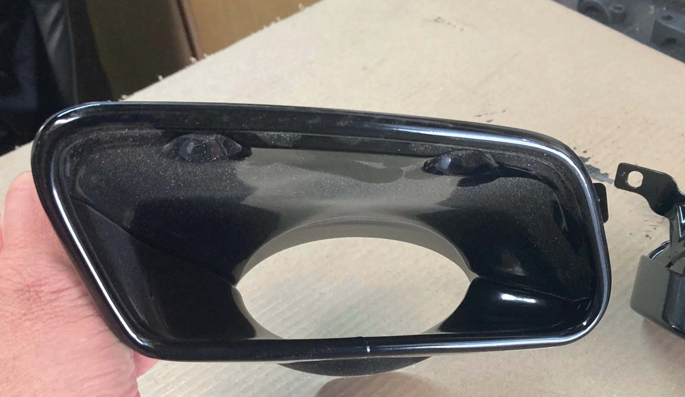 A ceramic-coated exhaust tip surround