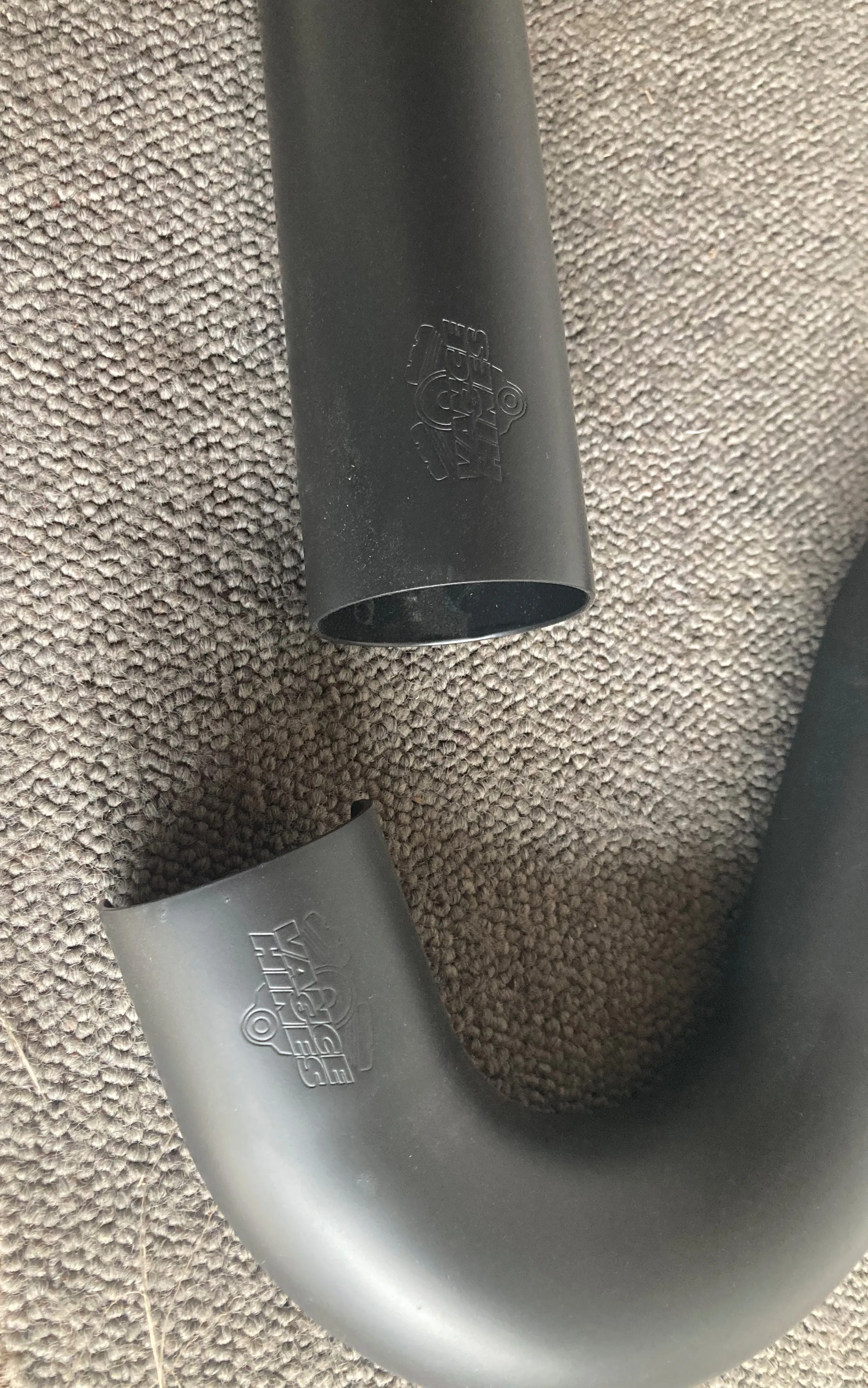 A close-up of a ceramic-coated motorcycle exhaust heat shield