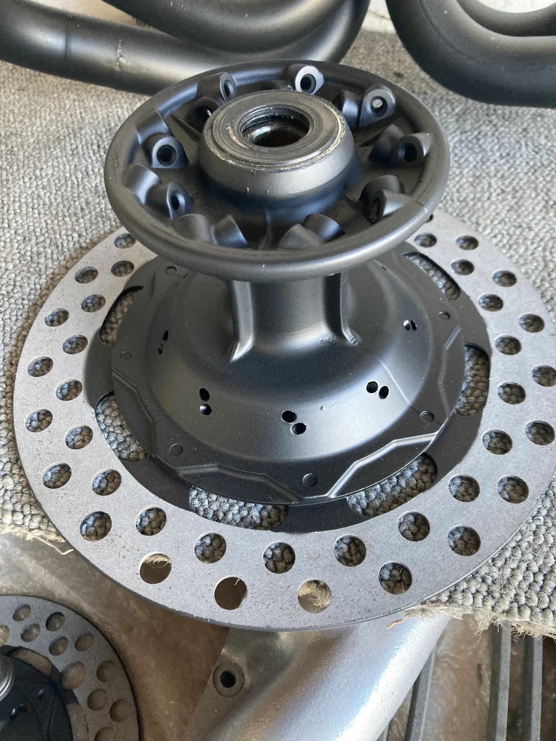 A close-up of a ceramic-coated motorcycle brake hub